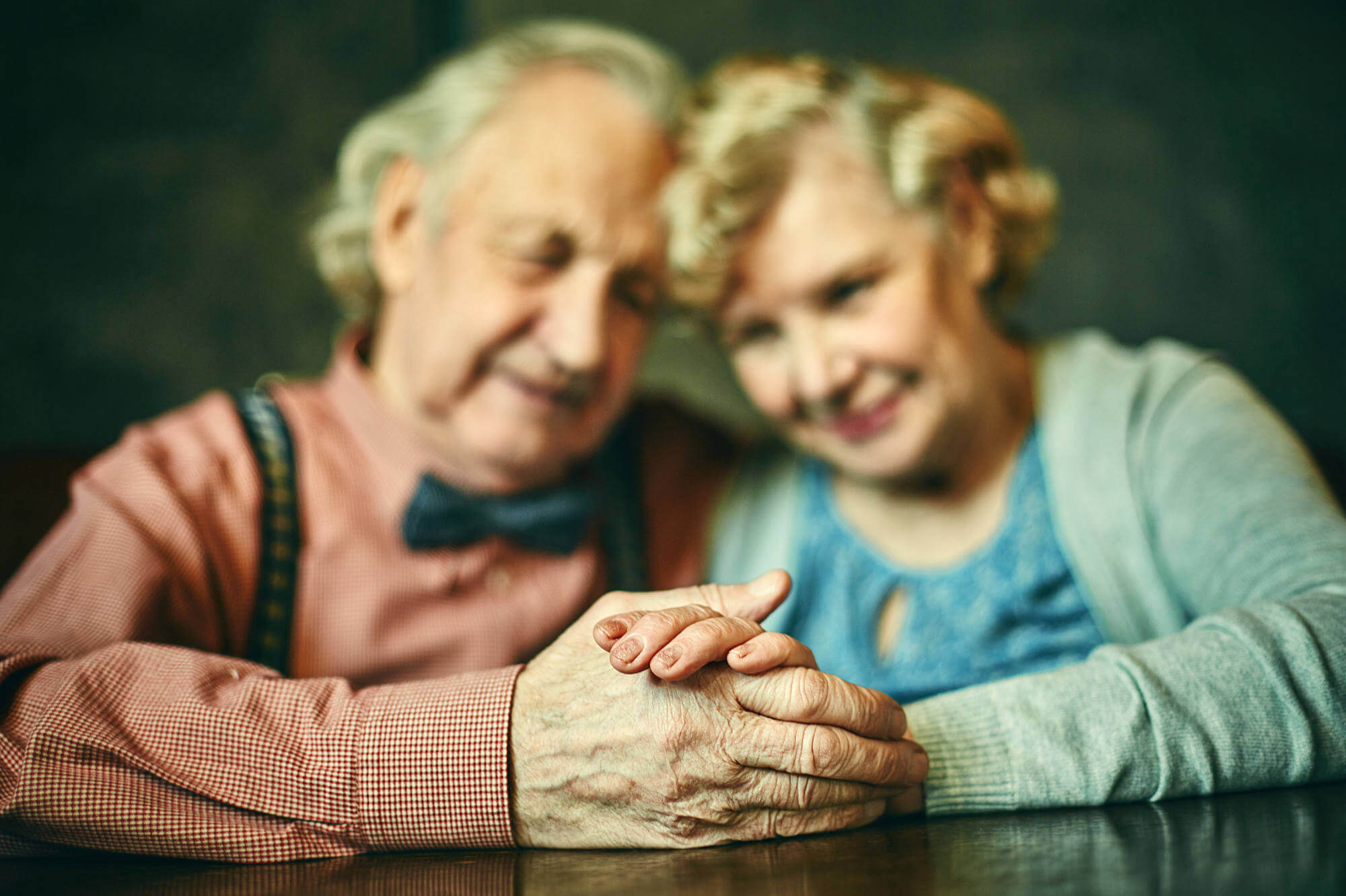 Close up on the hands of two affectionate seniors